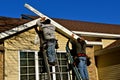 Constructions workers replacing facia on a house Royalty Free Stock Photo