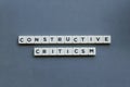 ' Constructive Criticism ' word made of square letter word on grey background Royalty Free Stock Photo