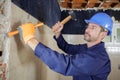constructon worker using hammer and chisel