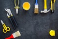 Constructor desk with set of building implements and brushes dark desk background top view mock up