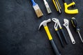 Constructor desk with set of building implements and brushes dark desk background top view mock up