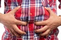 Constructor grabbing bloated stomach Royalty Free Stock Photo