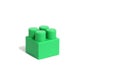 One green little brick, detail, on a white isolated background of their constructor set Royalty Free Stock Photo