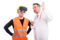 Constructor wearing virtual reality glasses with medic showing s