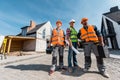 Constructors in helmets holding toolboxes