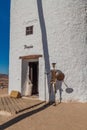 CONSUEGRA, SPAIN - OCTOBER 24, 2017: Don Quijote statue in front of a windmill in Consuegra village, Spa