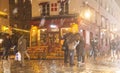 The Consulat French traditional cafe during snowfall. It is located in Montmartre, Paris, France. Royalty Free Stock Photo