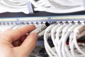 IT consultant connects a network cable into switch in datacenter Royalty Free Stock Photo