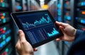 consultant examines server room performance metrics on tablet. Data analysis shows server room performance. Consultant reviews