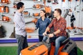 A consultant in a garden tools store shows a customer a lawn mower. Royalty Free Stock Photo