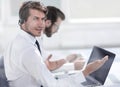 Consultant in headphones sitting at his Desk. Royalty Free Stock Photo