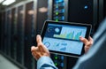 consultant inspects server room performance metrics on tablet. Reviews tech infrastructure design, security. Focus on tech Royalty Free Stock Photo
