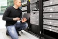 Consultant With Laptop Monitoring Servers In Datacenter Royalty Free Stock Photo