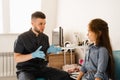 Consultation of kid with a pediatric otolaryngologist in a medical clinic. Nose examination of the child.