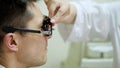 Consultation with an ophthalmologist. face close-up , ophthalmologist examining patient man with optometrist trial frame