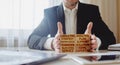 Consulting concept. man stacks wooden blocks with inscriptions analysis, strategy, plan, knowledge, teamwork, solution, expertise. Royalty Free Stock Photo