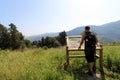 Consulting an explanatory panel during a walk in the mountains