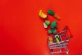 consumer basket.food cost.Rising food prices.Shopping cart with groceries on a red background.Vegetables and fruits Royalty Free Stock Photo