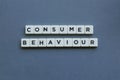 ' Consumer Behaviour ' word made of square letter word on grey background