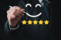 Consumer drawing a smiley face with a 5 star ratings, indicating their satisfaction with the service feedback.