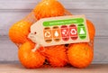 Consumer environmental sustainability rating label on bag of oranges with high, med and low ratings