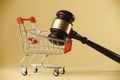 Consumer Rights Protection. Hammer of the judge with a trolley on a white background. Close-up Royalty Free Stock Photo