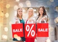 Happy young women with shopping bags in mall Royalty Free Stock Photo