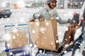 Customer loading food from shopping cart to car Royalty Free Stock Photo