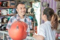 Consumers chat with shopkeepers when choosing a helmet