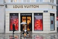 CONSUMERS AND TOURISTS PASS BY LOUIS VUITTONS TORE