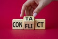 Contact and Conflict symbol. Businessman hand turns wooden cubes with words Contact and Conflict. Beautiful red background. Royalty Free Stock Photo