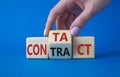 Contact and Contract symbol. Businessman hand points at turned wooden cubes with words Contract and Contact. Beautiful blue Royalty Free Stock Photo