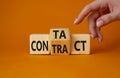 Contact and Contract symbol. Businessman hand points at turned wooden cubes with words Contract and Contact. Beautiful orange Royalty Free Stock Photo