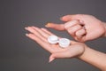 Contact eye lens. Close-up of woman hands holding white eyelense container. Royalty Free Stock Photo