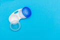 Contact lens case open on a bright blue flat lay background. Vision, healthcare, eye sight concepts Royalty Free Stock Photo