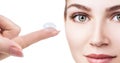 Contact lens on index finger near beautiful female face. Royalty Free Stock Photo