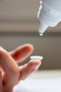 Contact lense cleaning on finger to correct nearsightedness and blurred vision eyesight by optician or oculist