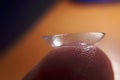 Contact lense on finger tip, macro. Contact lenses macro close up. Man holding lens on finger. Customer, patient or eye doctor, Royalty Free Stock Photo