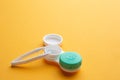Contact lenses and accessories: container for lenses and tweezers. Yellow background Royalty Free Stock Photo