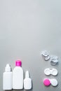 Contact lenses and accessories flat lay on a gray background. Composition with solution bottles and lens case Royalty Free Stock Photo