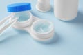 Contact lenses in case with solution liquid on blue background, cleaning contact lens Royalty Free Stock Photo