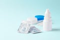 Contact lenses with eye drops and accessories on blue background Royalty Free Stock Photo