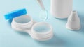 Contact lenses with tweezer, container and solution bottle on light blue background Royalty Free Stock Photo