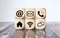 Contact Methods. Close-up of a phone, email, chat and post icons wooden block Royalty Free Stock Photo