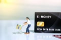 Contact-less payment. A men going shop and pay using electronic money e-money. Miniature people figurines toys conceptual