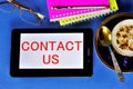 Contact us-business interactions. A written message on a tablet PC. To communicate, you need the phone number or email address of