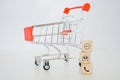 Contact us concept, contact icon on stack of wood cubes with blurred shopping cart, sale promotion, advertising, online shopping Royalty Free Stock Photo