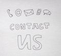 Contact us handwritten lettering on white paper on dark