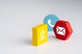 Contact us icon on colorful puzzle with hand Royalty Free Stock Photo