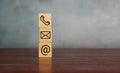 Contact us icon on wooden cubes. Copy space for text Royalty Free Stock Photo